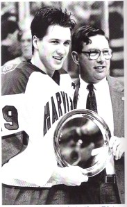 Lane MacDonald accepts MVP trophy from Garden VP Steve Nazro after Harvard defeated BU 9-6 for the 1989 Beanpot title. 